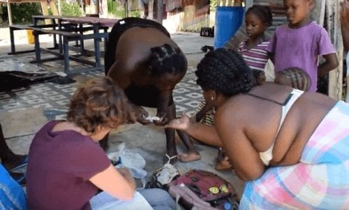 Maroon women looking at types of rice.